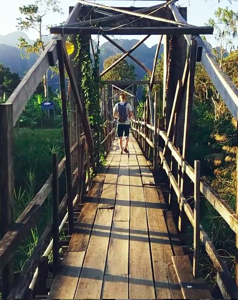 Walking across bridge in Laos
