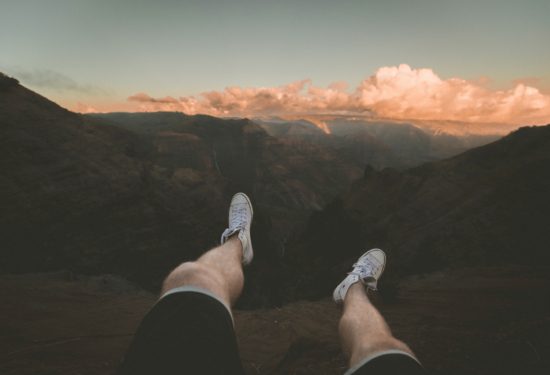 Man sitting on mountain top free